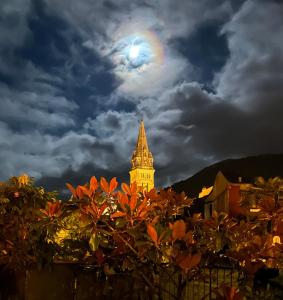 卢尔德BASIA, Lourdes - centre , quartier historique Sanctuaires a 7 min a pied的天空中月亮钟楼的景色