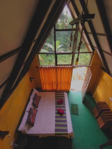 代尼耶耶Rainforest cabin的阁楼间设有床和大窗户