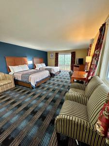 北康威瑞士小屋村旅馆的酒店客房,设有两张床和一张沙发