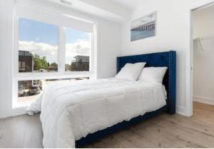 尼亚加拉瀑布Luxury Suite 4mins To Falls的卧室配有蓝色和白色的床和窗户。
