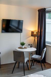 巴特塞格贝格Studio Apartment am Kurpark的客厅配有桌椅和台灯