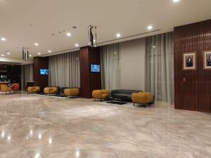 塞拉莱KYRIAD HOTEL SALALAH的大堂设有带桌椅的等候室