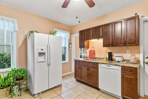 布里奇波特Bedroom near Yale Hospital/Bridgeport的厨房配有白色冰箱和木制橱柜。
