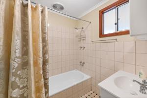 克莱尔克莱尔谷小屋假日公园的浴室配有淋浴帘和盥洗盆。