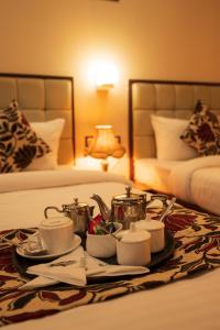 西里古里Rajdarbar Hotel & Banquet, Siliguri的一间酒店客房内的桌子上放着茶盘