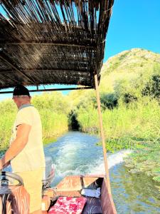 VranjinaEthno village Moraca - Skadar lake的站在河里的船上的人