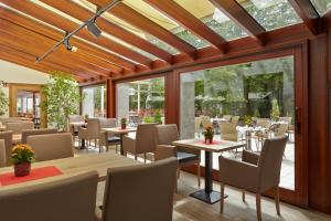 绍埃尔拉绍尔拉赫普斯特酒店的用餐室设有桌椅和窗户。