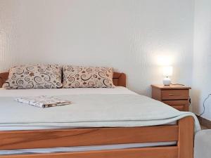 布德瓦MM Apartments的一间卧室配有带枕头和床头柜的床