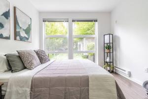 西雅图One bedroom luxury apartment (Gym, Wifi, Parking, Rooftop Deck)的一间卧室设有一张大床和一个窗户。