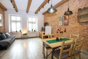 瓦乌布日赫Apartament Gwarek的一间设有砖墙和桌椅的客厅