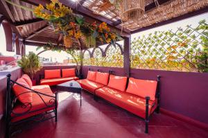 马拉喀什Riad Sidi Mimoune & Spa的一个带红色长椅和围栏的门廊