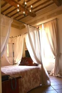 贝瓦尼亚珀塔古尔法酒店的一间卧室配有白色窗帘的床