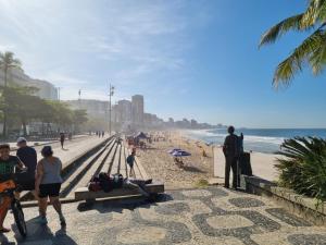 里约热内卢SUÍTE c vista livre e pertíssima das PRAIAS IPANEMA LEBLON ARPOADOR COPACABANA do CRISTO REDENTOR e do BONDINHO PÃO DE AÇUCAR etc com Pré Check In antes do meio-dia chegue cedo e deixe suas coisas no quarto ao lado e vá curtir logo cedo Pós Check Out idem的一群站在海滩上的人