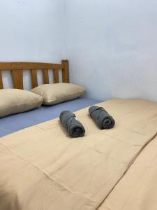 Kampong MolekRUMAHREHAT的卧室内的两张床上的两个枕头