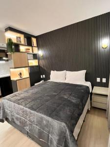戈亚尼亚Flat Pleasure的一间卧室设有一张大床和黑色墙壁