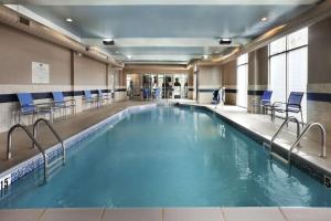 哥伦布Homewood Suites by Hilton Columbus OSU, OH的大楼内带蓝色椅子的大型游泳池
