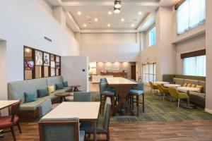 西切斯特Hampton Inn & Suites Cincinnati Liberty Township的一间带桌椅的用餐室和一间自助餐厅