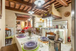 卢卡Villa Casale Le Selve的厨房配有带盘子的桌子