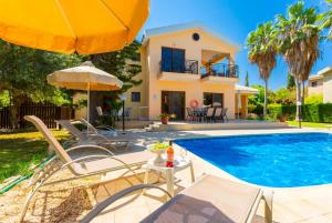 波利斯Villa Halima Stefanos的一座带游泳池和房子的别墅
