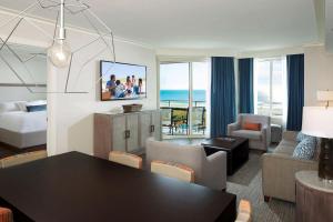 希尔顿黑德岛Hilton Grand Vacations Club Ocean Oak Resort Hilton Head的一间带餐桌的客厅和一间享有美景的客厅