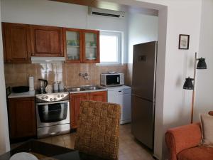 蒂瓦特Apartment Casa sul Mare的厨房配有炉灶和冰箱。