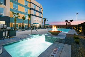 拉斯维加斯Hampton Inn Las Vegas Strip South, NV 89123的大楼前的一个带火坑的游泳池