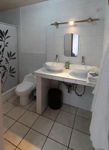 危地马拉Hotel Bluehouse的一间带两个盥洗盆和卫生间的浴室