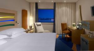 利物浦利物浦丽笙酒店的配有一张床、一张书桌和一扇窗户的酒店客房