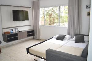 伊瓜苏港Aires de Cataratas的酒店客房设有两张床和一台平面电视。