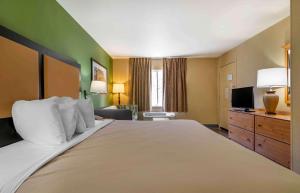 Merriam堪萨斯城 - 沙尼米逊美国延住公寓式酒店的酒店客房设有一张大床和一台电视。