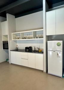 迈普Bosques de Mayo的厨房配有白色橱柜和白色冰箱。