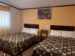 奇格纳瓦潘Hotel Santa Fe的酒店客房设有两张床和窗户。