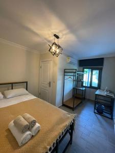 乌尔拉Zu Tiny House Hotel & Restaurant的一间卧室配有带毛巾的床