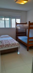 瓜鲁雅CARIBONI的一间卧室配有两张双层床。