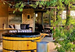 HoekwilLibertas Guest Farm的一个带沙发和酒桶的庭院