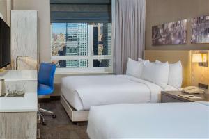 纽约纽约时代广场西希尔顿逸林酒店的酒店客房设有两张床和窗户。