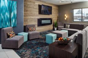 尼纳尼纳希尔顿逸林酒店 的客厅配有沙发、椅子和电视