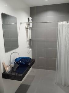曼谷D Night Suite Hotel的浴室配有蓝色卫生间和淋浴。