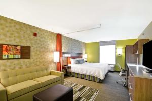 拉皮德城Home2 Suites By Hilton Rapid City的酒店客房,配有床和沙发