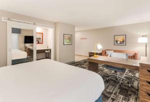 本顿港Hampton Inn & Suites Benton Harbor, MI的配有一张床和一张书桌的酒店客房