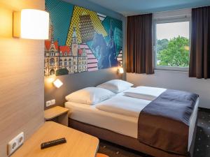 汉诺威B&B Hotel Hannover-Lahe的酒店客房设有床和窗户。