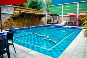 阿劳卡Hotel Punta Arena Spa Boutique的一座建筑物边的蓝色瓷砖游泳池