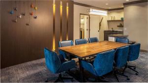 奥斯汀希尔顿奥斯汀机场酒店的一间会议室,配有木桌和蓝色椅子