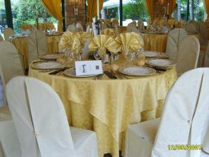 纳托鲁斯提契洛酒店的一张桌子,上面有黄色的桌布,盘子和椅子