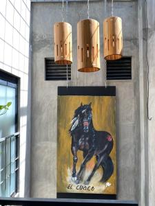 埃斯孔迪多港Casa Conicarit的墙上一幅黑色马的画,上面有灯光