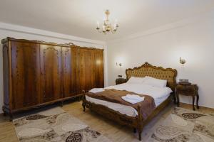 巴亚马雷CASA BARONULUI的一间卧室配有一张带木制家具和吊灯的床。