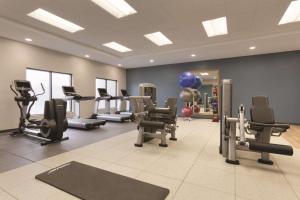 北坎顿阿克伦坎顿机场希尔顿尊盛酒店的健身房,配有跑步机和健身器材