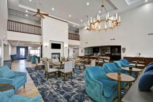 棕榈荒漠棕榈沙漠希尔顿惠庭套房酒店 的酒店大堂设有蓝色的椅子和桌子。