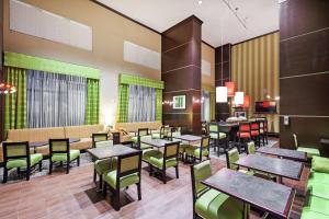 利格城休斯顿/利格城汉普顿套房酒店的用餐室配有桌子和绿色椅子