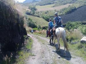 伊瓦拉Kawsay- Hospedaje y Alimentacion的两个人在土路上骑马